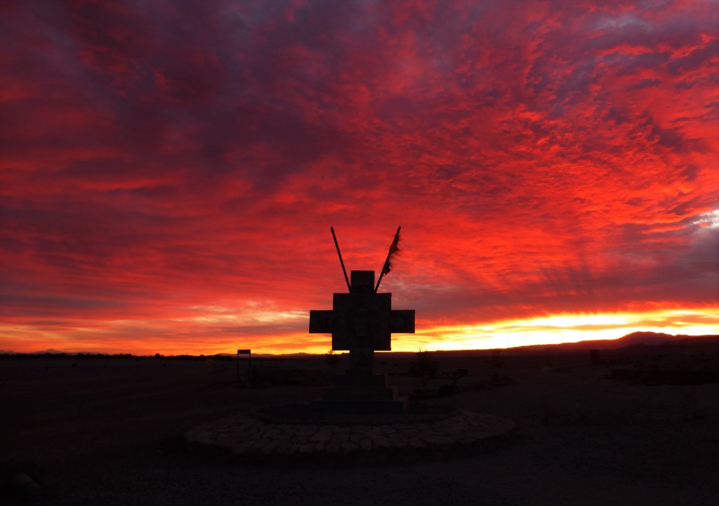 Sunset behind an Andean Cross