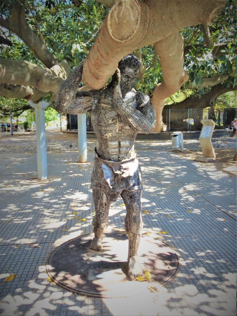 Creative sculpture holding up an old tree